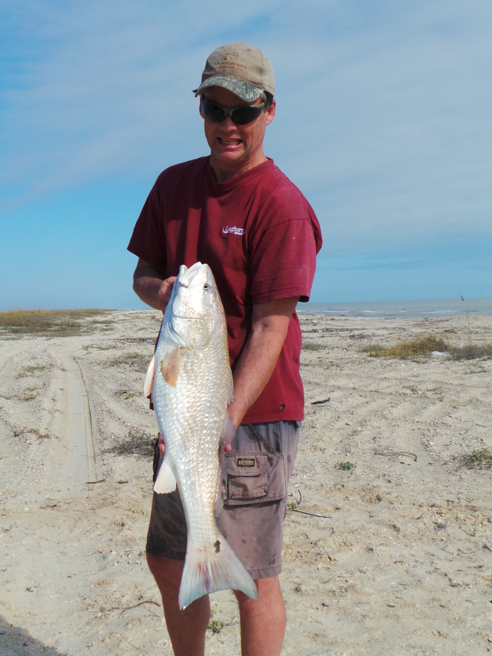 Catching redfish from the surf - author with a nice redfish caught from the surf at Matagorda Beach Texas