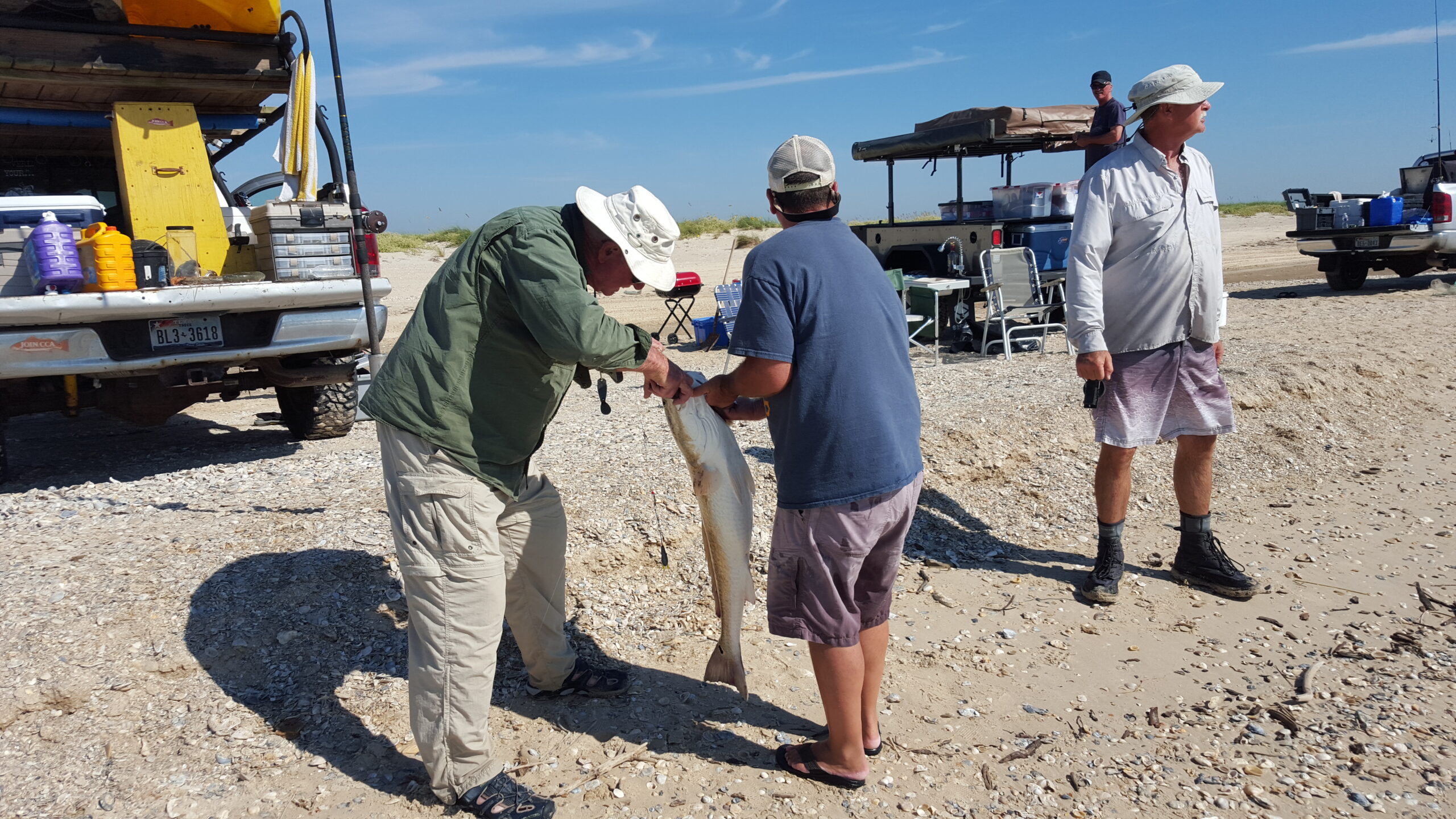 Unhooking an oversized redfish caught on Matagorda beach. CPR to fight another day