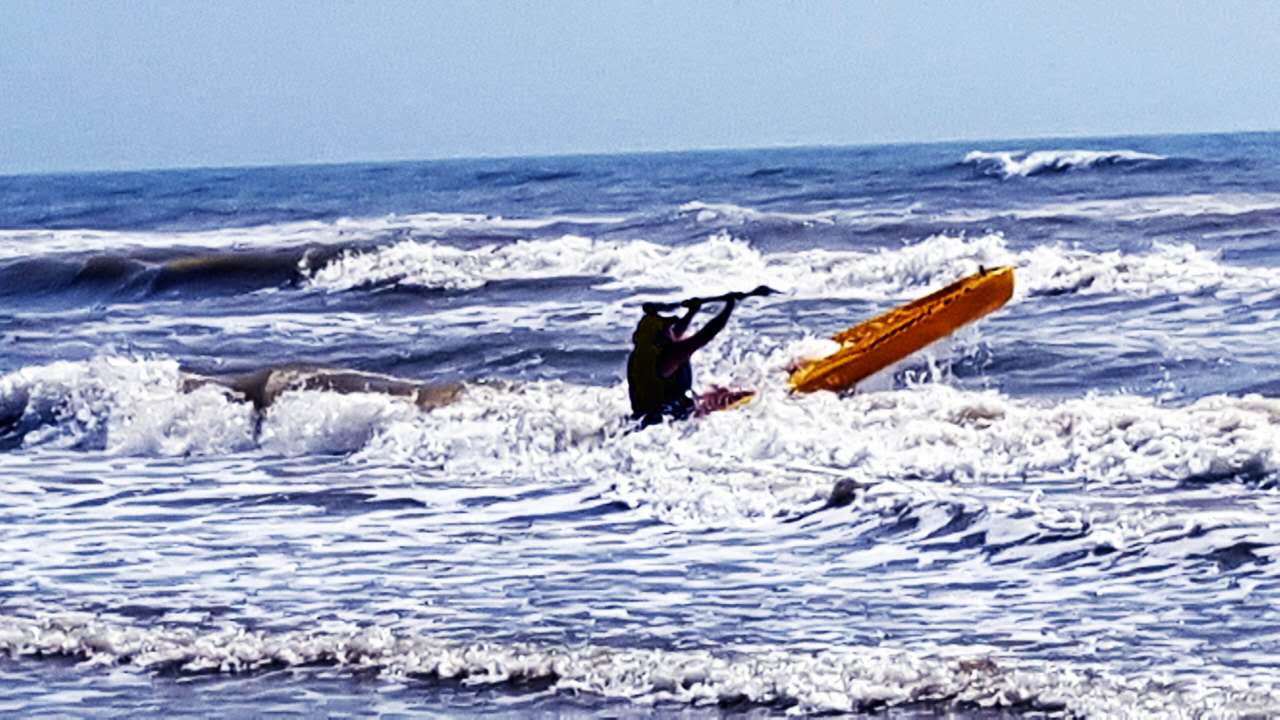 fishing in a kayak in the surf