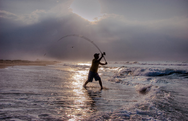 Surf fishing south padre island texas - surf fisherman making a cast from the beach