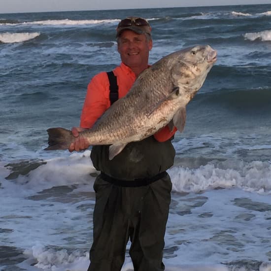 Author with a big black drum caught from the surf.