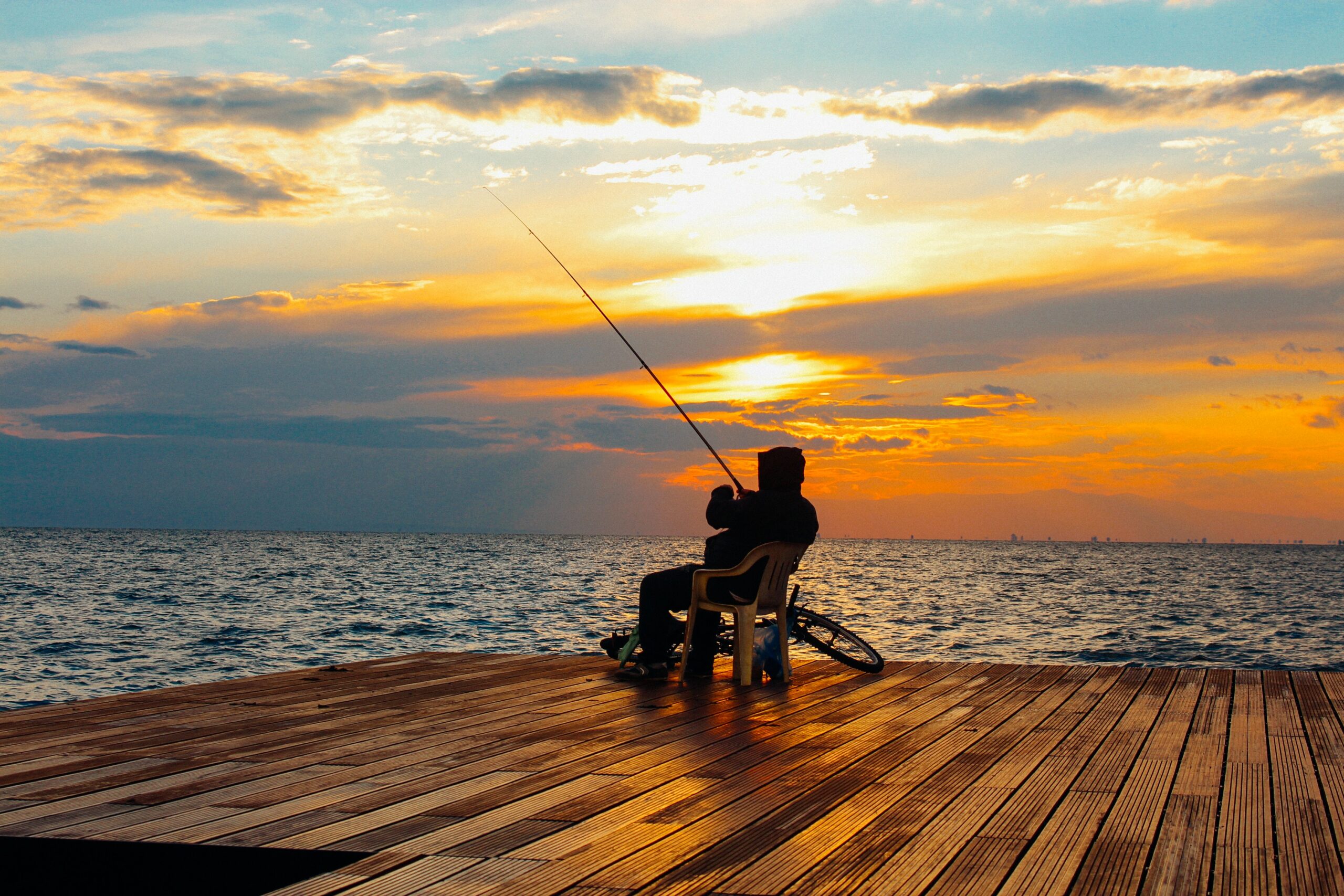 Fishing on a pier at sunrise - Start your own fishing and outdoor blog