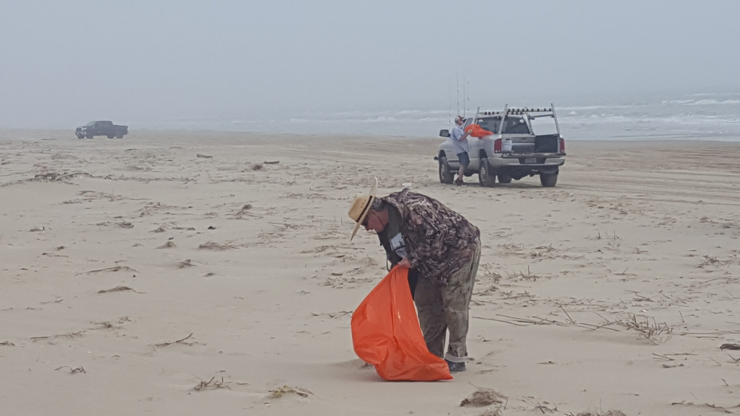 Pat Watkins picking up trash at the Billy Sandifer Big Shell Beach Clean up
