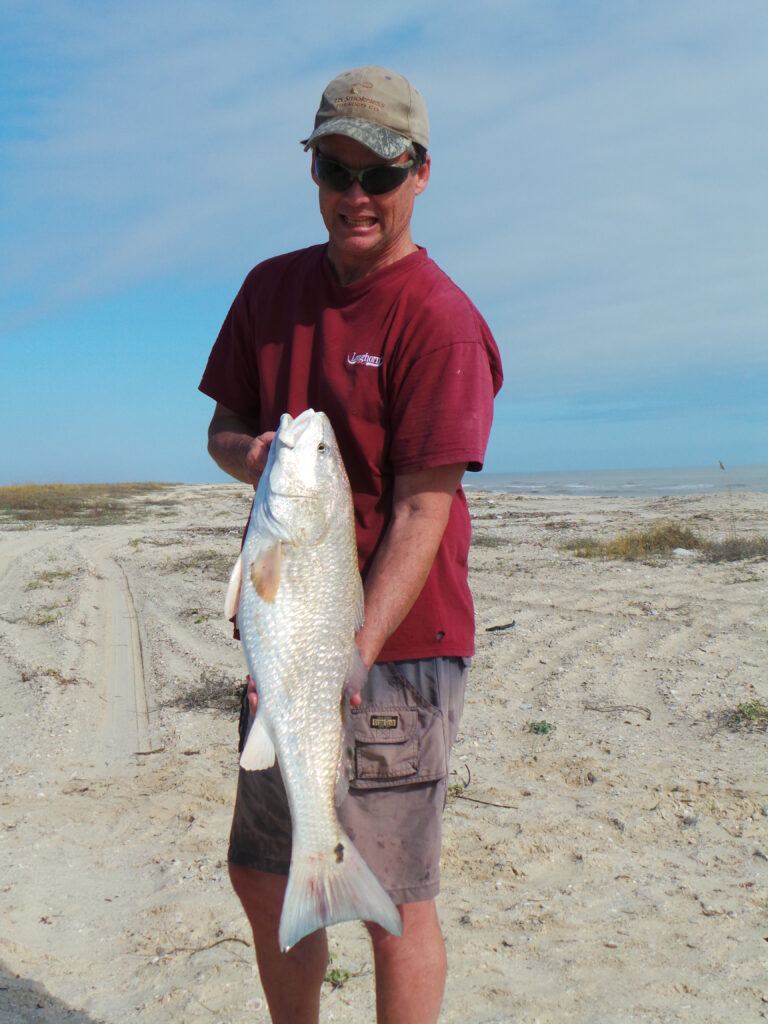 Rex McMahon with bull redfish on Matagorda Beach Texas