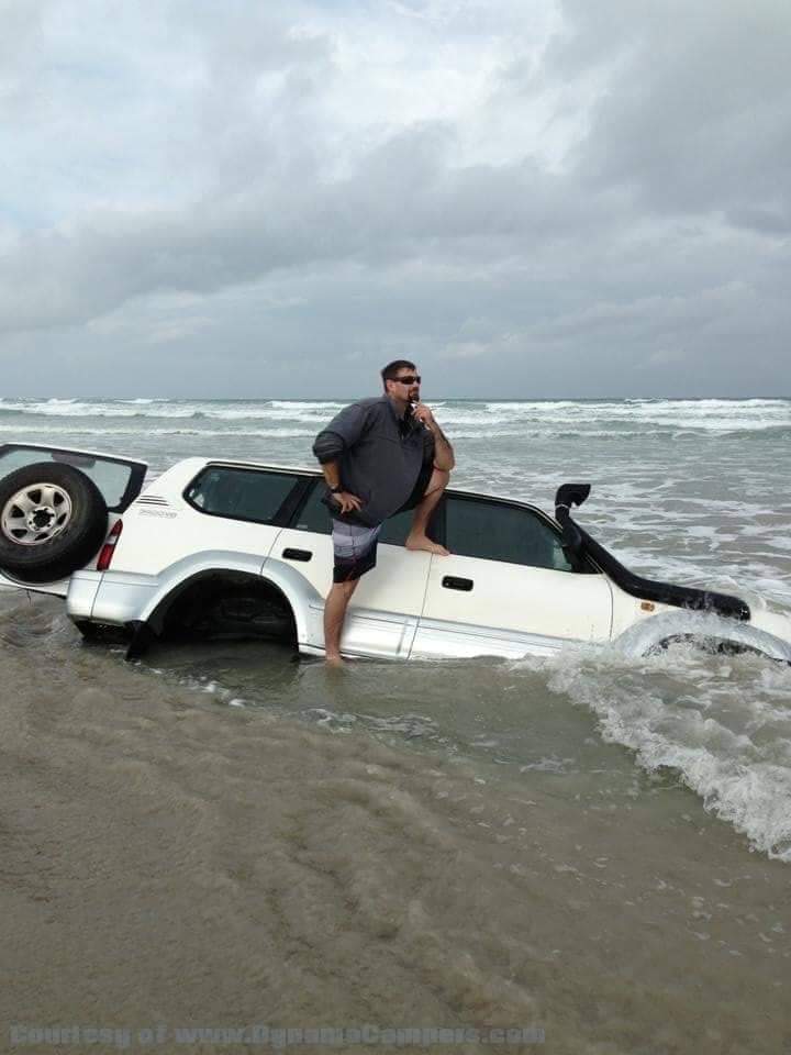 Vehicle caught in a rising tide on the beach and now buried in the sand.