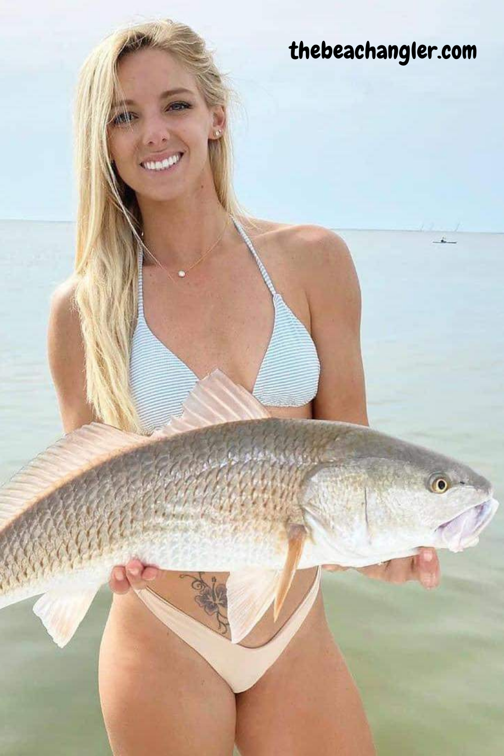 Fishing lady with an oversized redfish