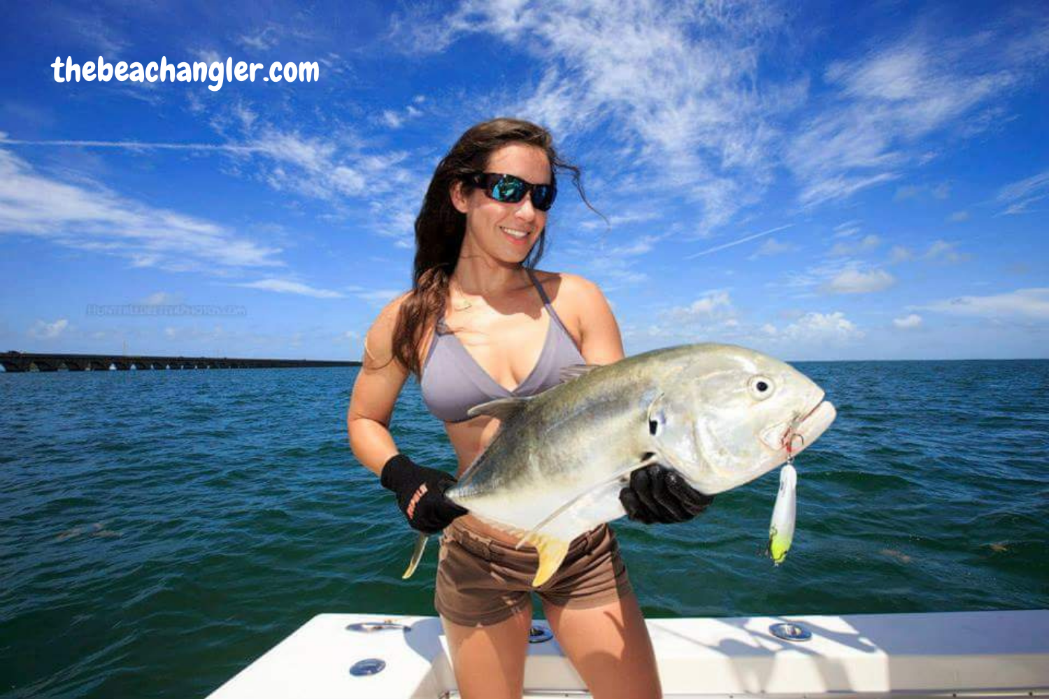 Lady with a large Jack Crevalle caught off the beach