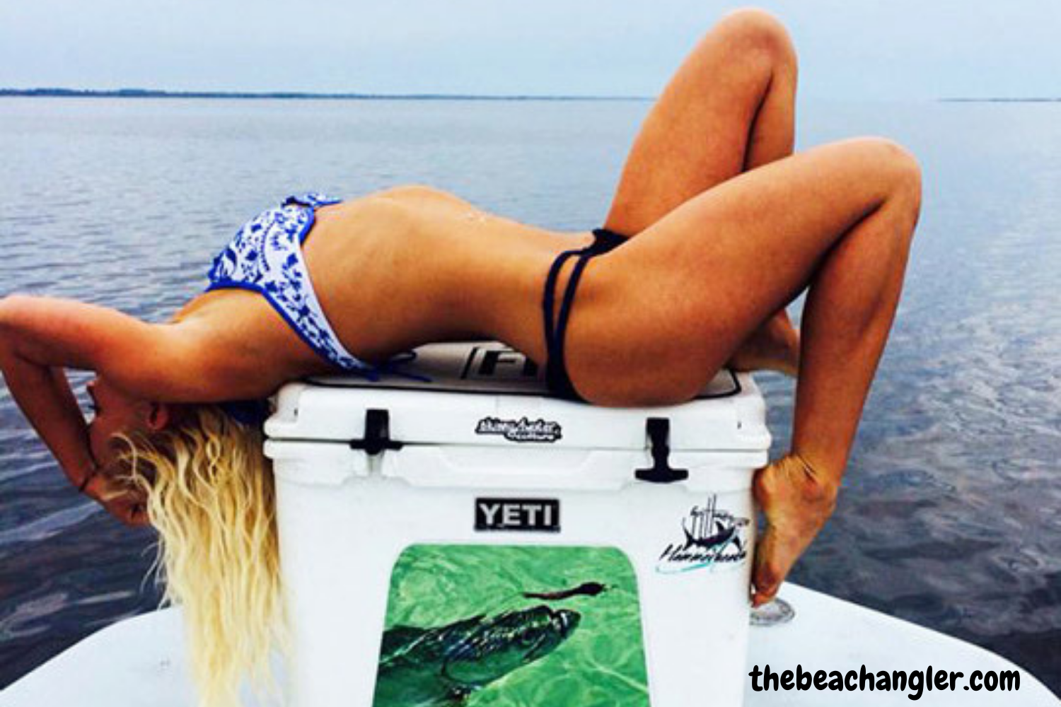 Lady relaxing on top of a Yeti Tundra cooler