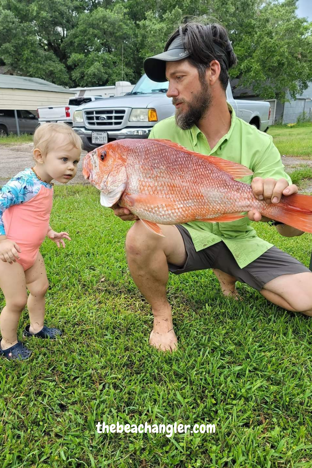 Dad showing his daughter a large Red Snapper - Take Your Dad Fishing