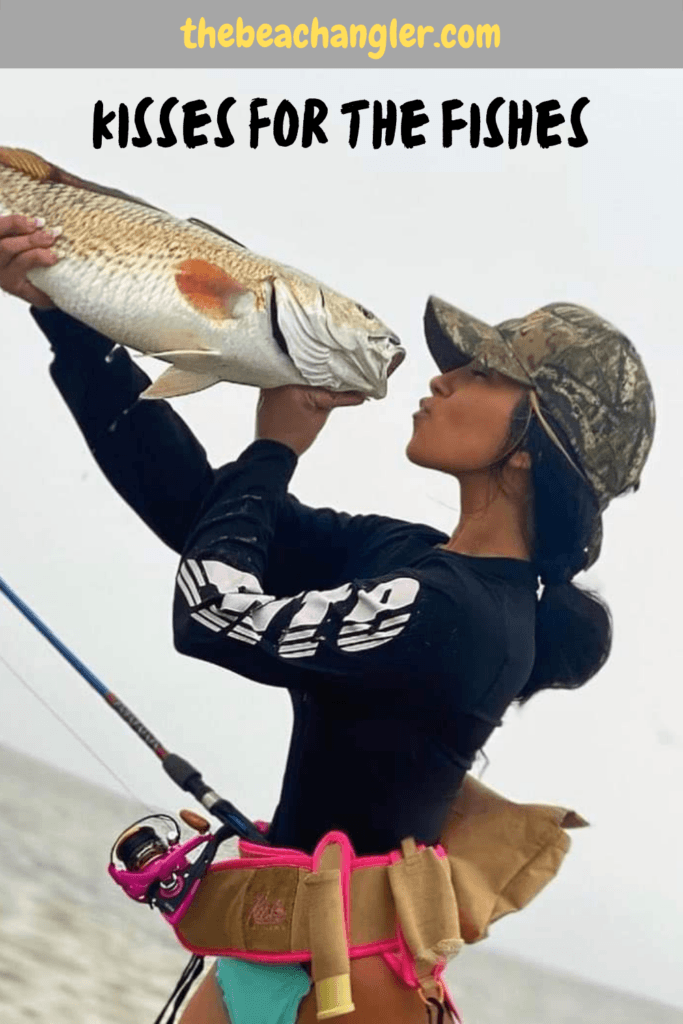 Kisses for the fishes - Young lady with a nice redfish caught using a spinning rod and reel combo