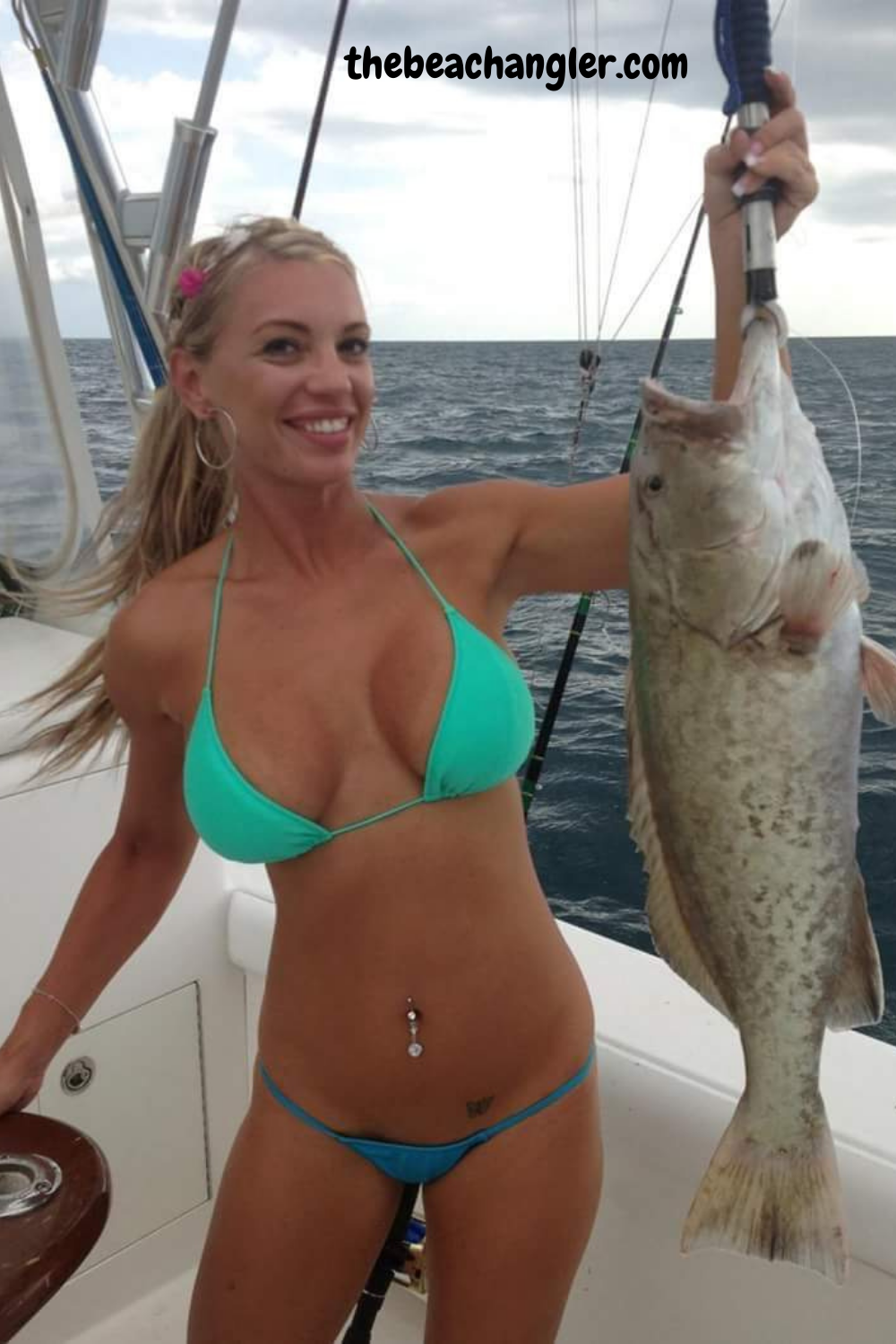 Lady with a nice grouper caught using a Penn Slammer rod.