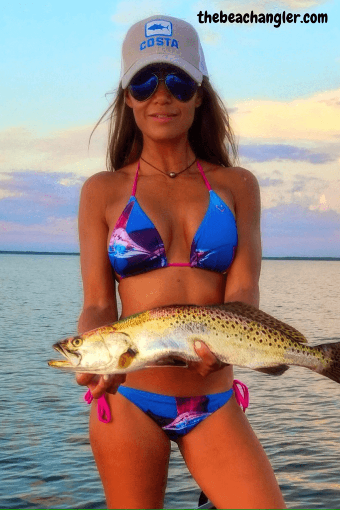 Lady with a nice speckled trout caught while fishing the beach