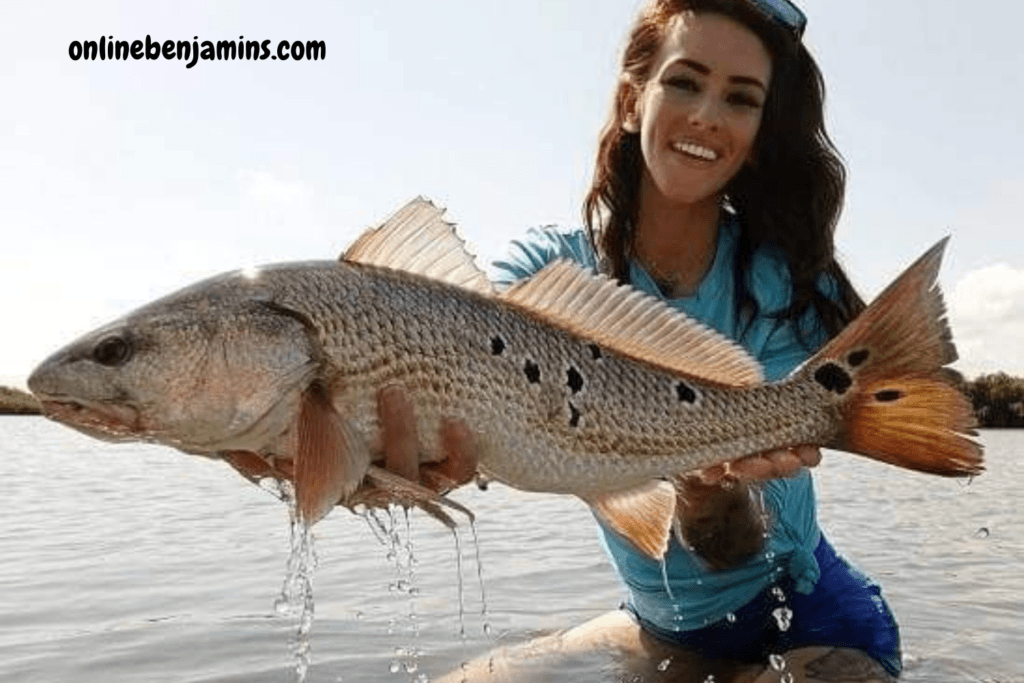 Young lady with a nice redfish. Surf Fishing Tackle bags
