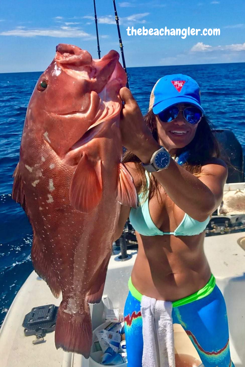 Lady holding a large grouper. Fishing Rod Racks for Your Vehicle