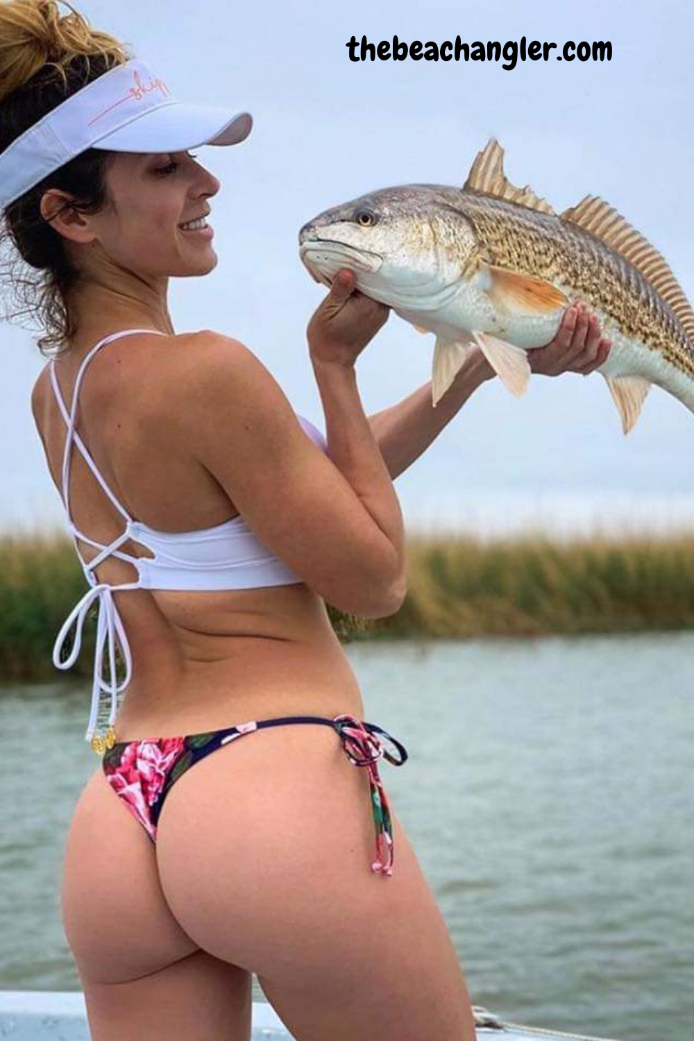 Young lady with a nice upper slot redfish caught with an Okuma rod.