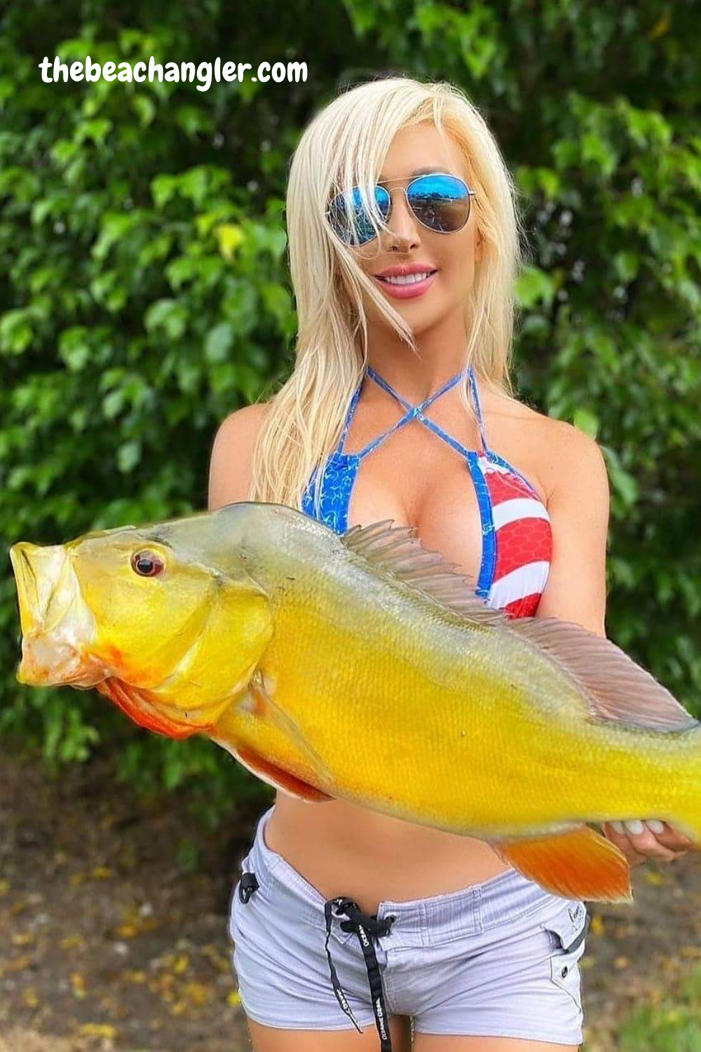 Young Lady with a big Peacock Bass caught with her Shimano spinning reel.