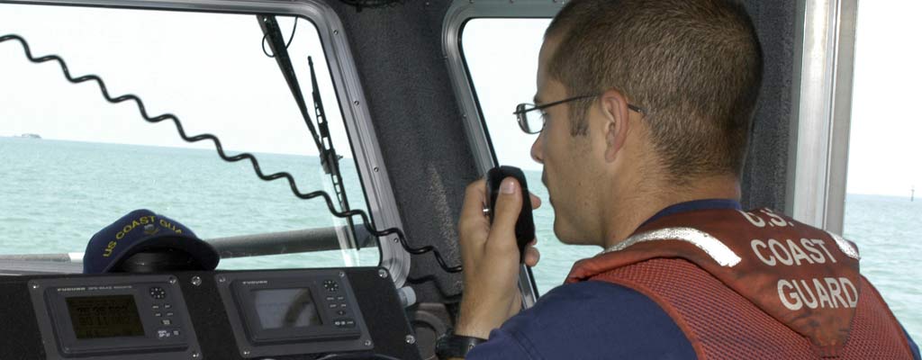 Coast Guard talking on a marine radio - Cobra marine radios review