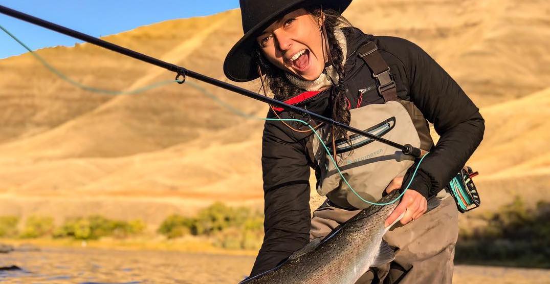 Lady with a nice rainbow trout caught while wearing her Ibex Outdoor Clothing merino wool jacket