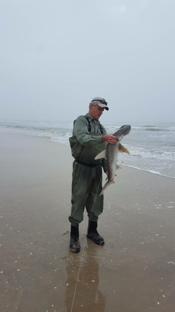 Author with a nice bonnethead shark - surf fishing in windy conditions