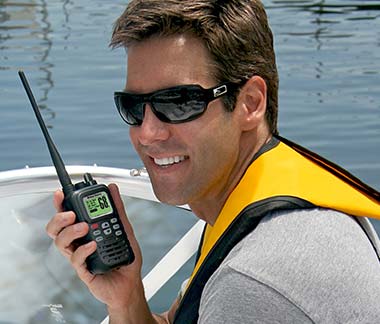 Man talking on his handheld marine radio - Cobra marine radios review