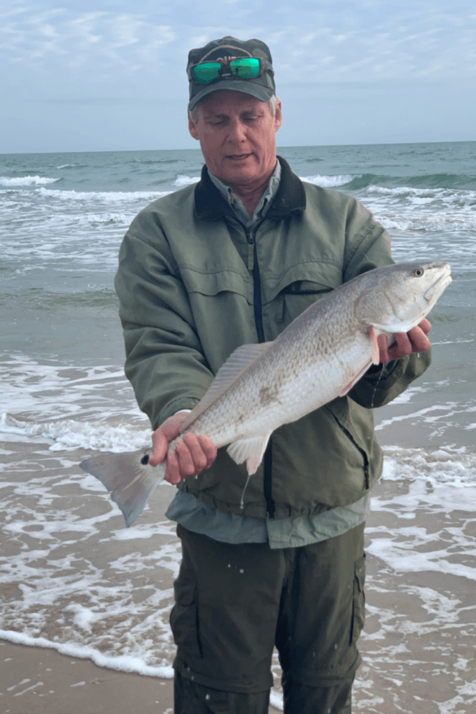 Rex McMahon with a nice slot red drum from the Texas surf