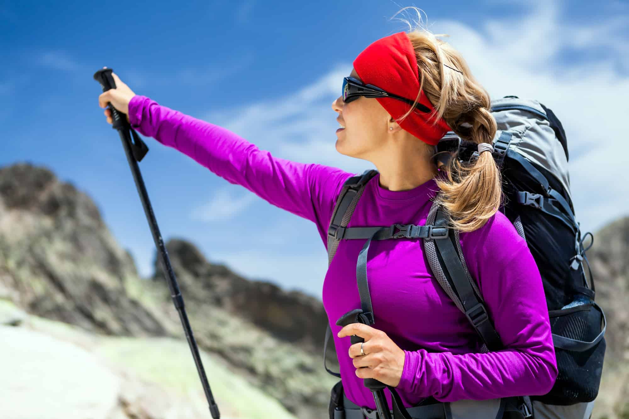 Lady hiking up the mountain in her Ibex Merino Wool base layer shirt. - Merino wool for outdoor clothing