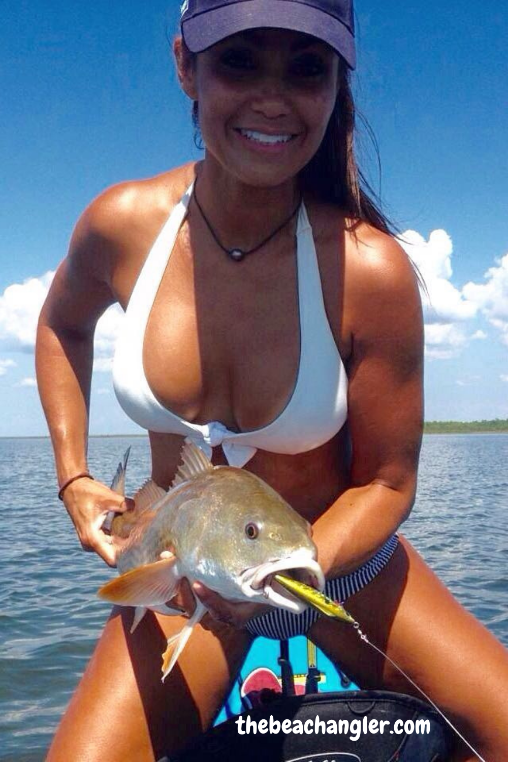 lady with a nice redfish caught fishing from her kayak