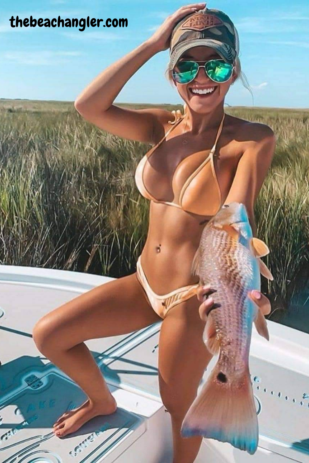 Young lady with a nice slot redfish - FishBrain fishing app review