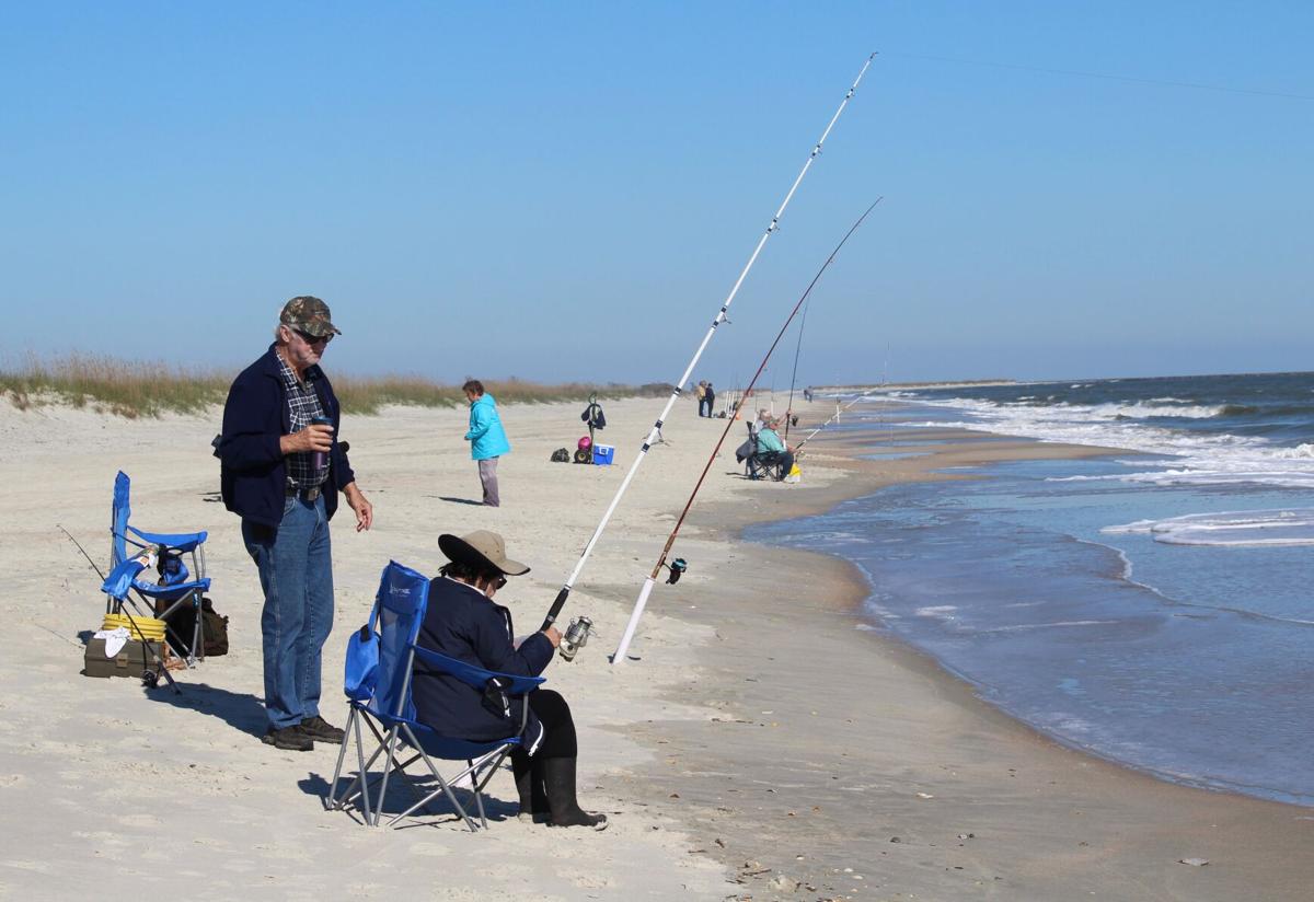 older couple surf fishing near a beach point