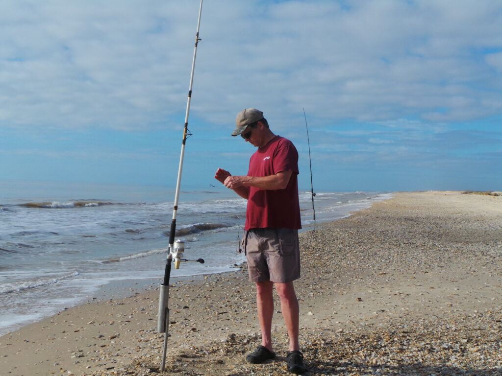 Author rigging up with his Shimano Spheros SW spinning reel to do some surf fishing on Matagorda Beach Texas