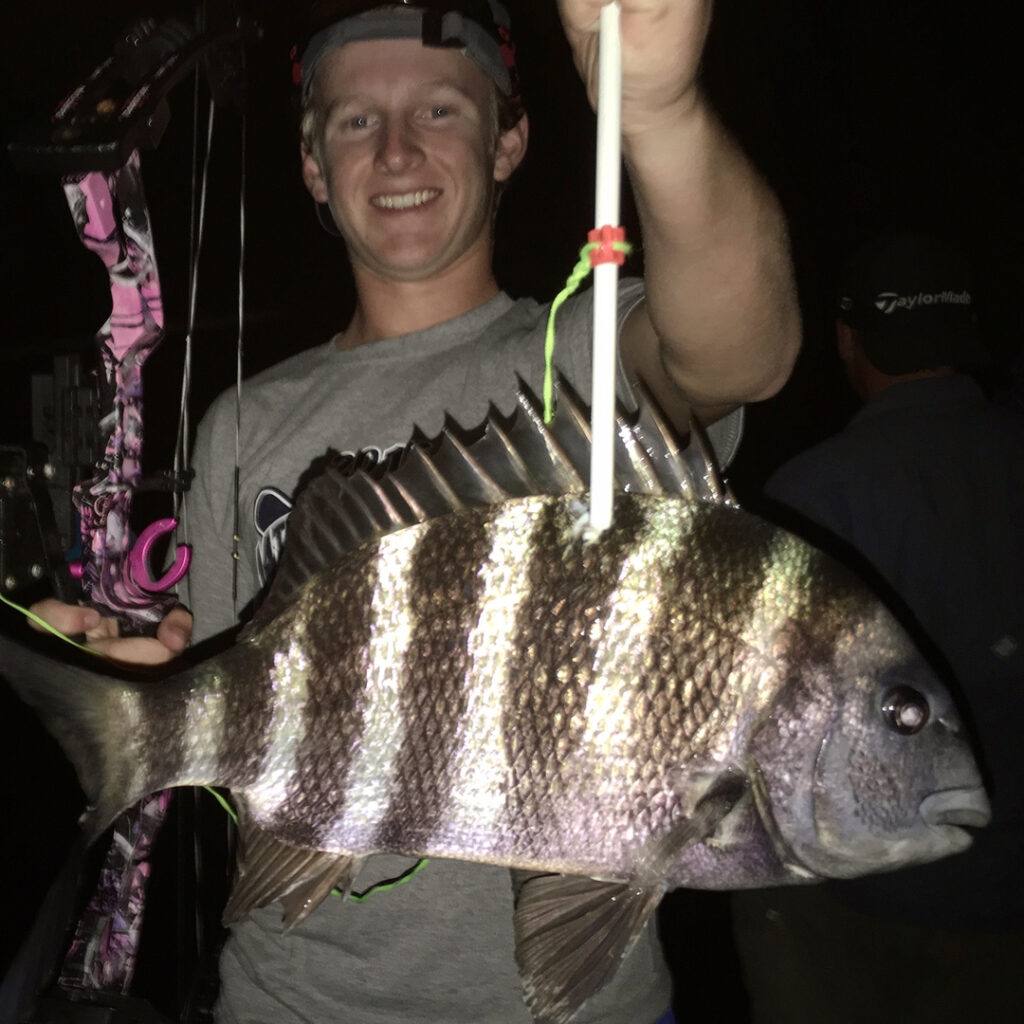 bowfishing how to for beginners - young bowfisherman with a nice sheepshead