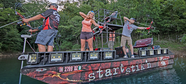 bowfishing how to for beginners - 3 bowfishermen on a nice boat rigged specially for bowfishing.