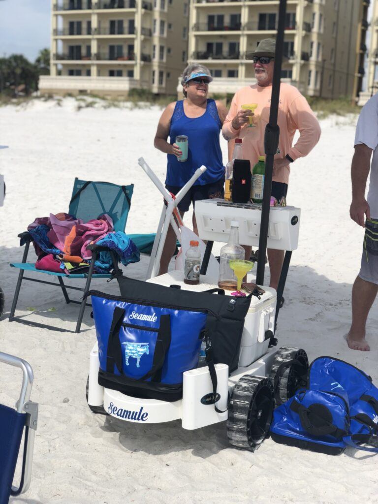 Seamule wade an beach fishing cart review - couple on the beach with their loaded Seamule beach cart