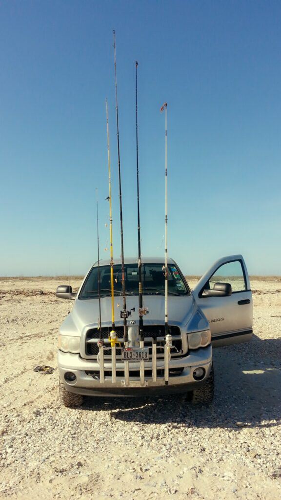 Basic Surf fishing equipment for beginners - selection of surf rods in the vehicle rod rack on the front of a pickup