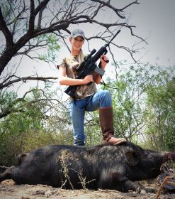 Hunting in Texas - Young lady with a big Texas boar wild hog