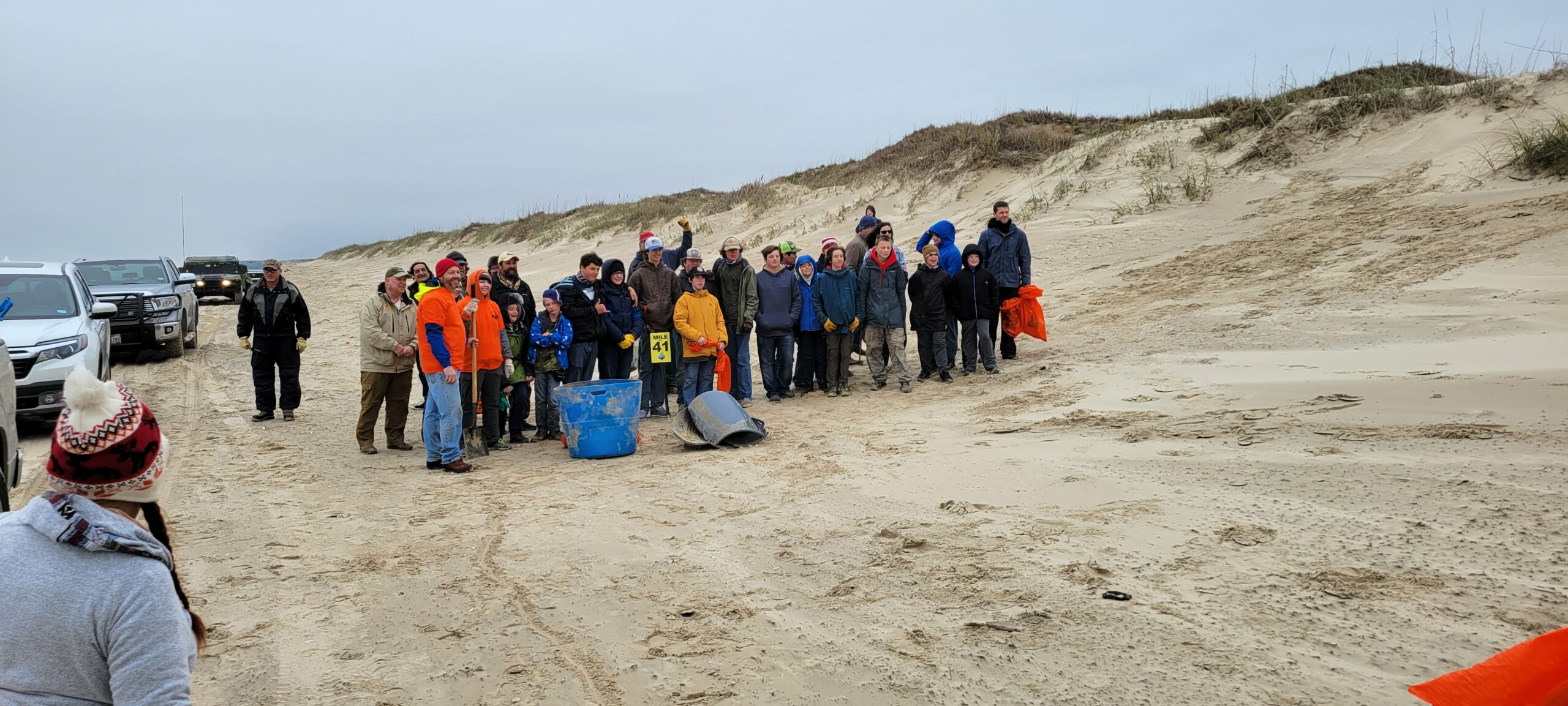 Billy Sandifer Big Shell Beach Cleanup - volunteers standing at the finish line, the 41 mile marker after cleaning from the 42 to the 41.