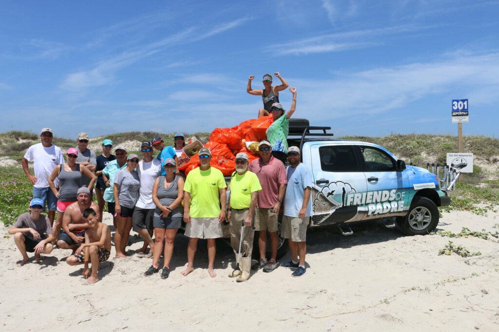 Captain Billy Sandifer and the Friends of Padre loading up the truck with backs of trash