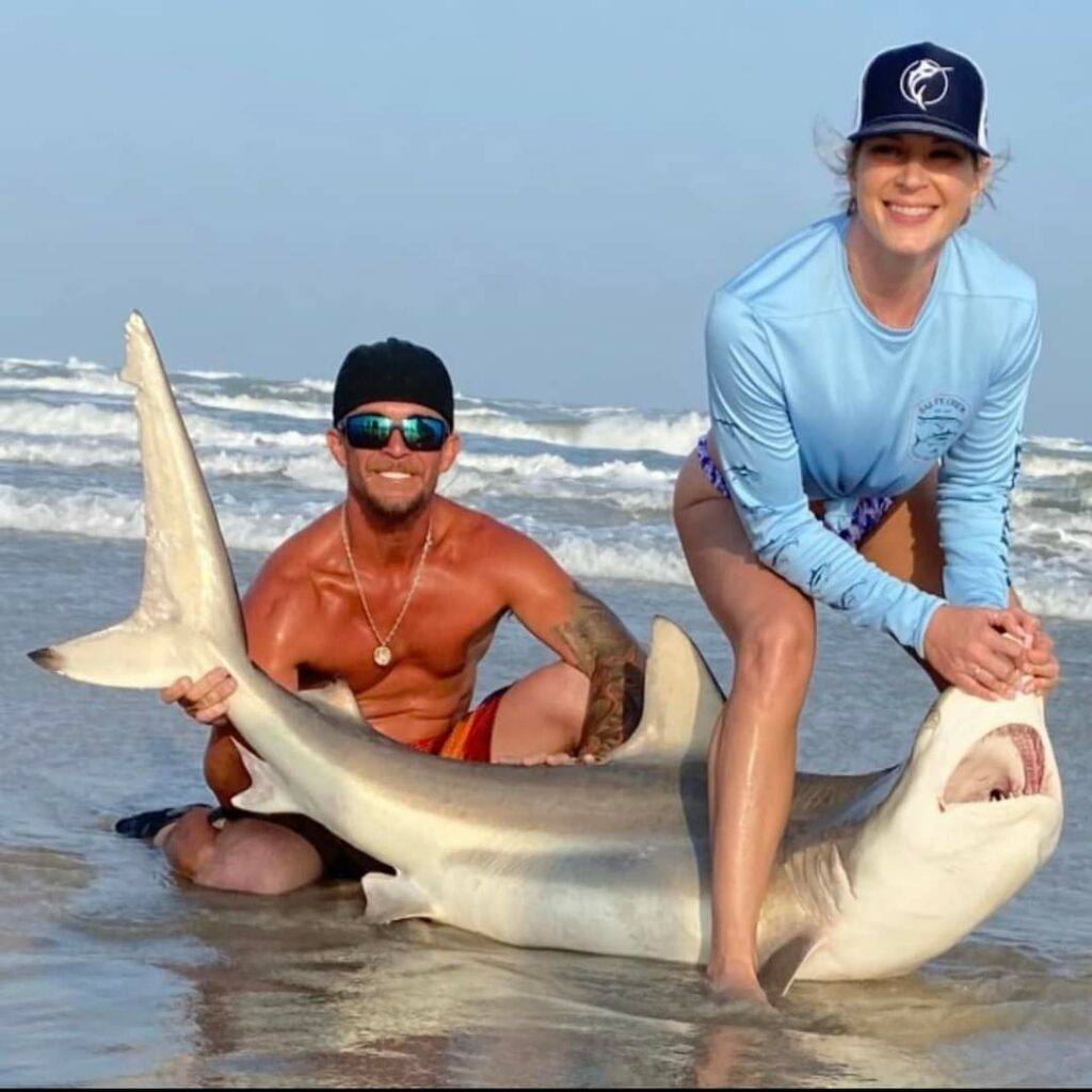 Couple with a nice shark caught from the beach