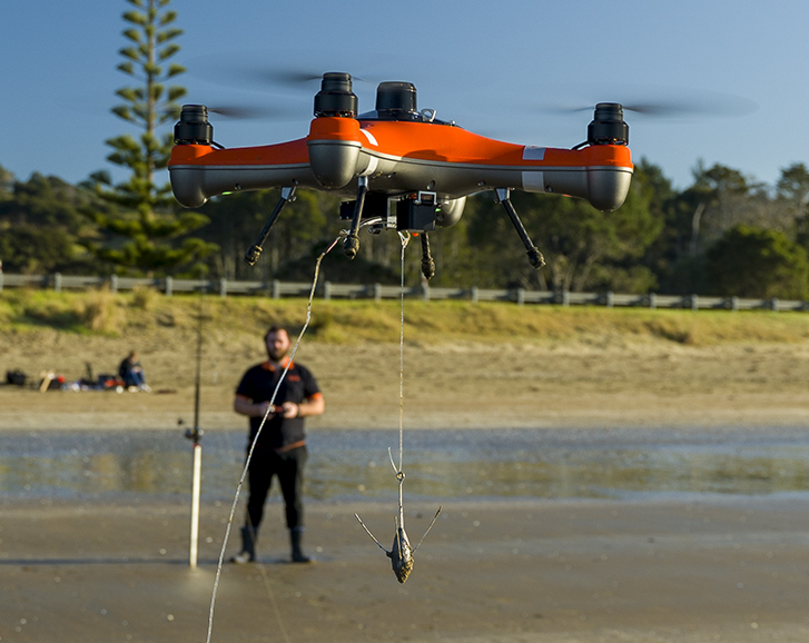 SwellPro Fisherman FD1 fishing drone flying out to drop a bait