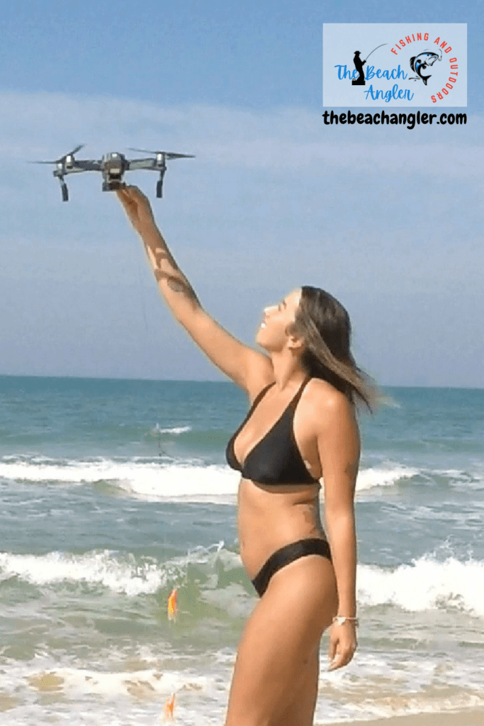 SwellPro fisherman FD1 fishing drone review - young lady launching her fishing drone from the beach