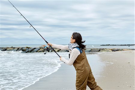 surf fishing waders - lady surf casting in her chest waders
