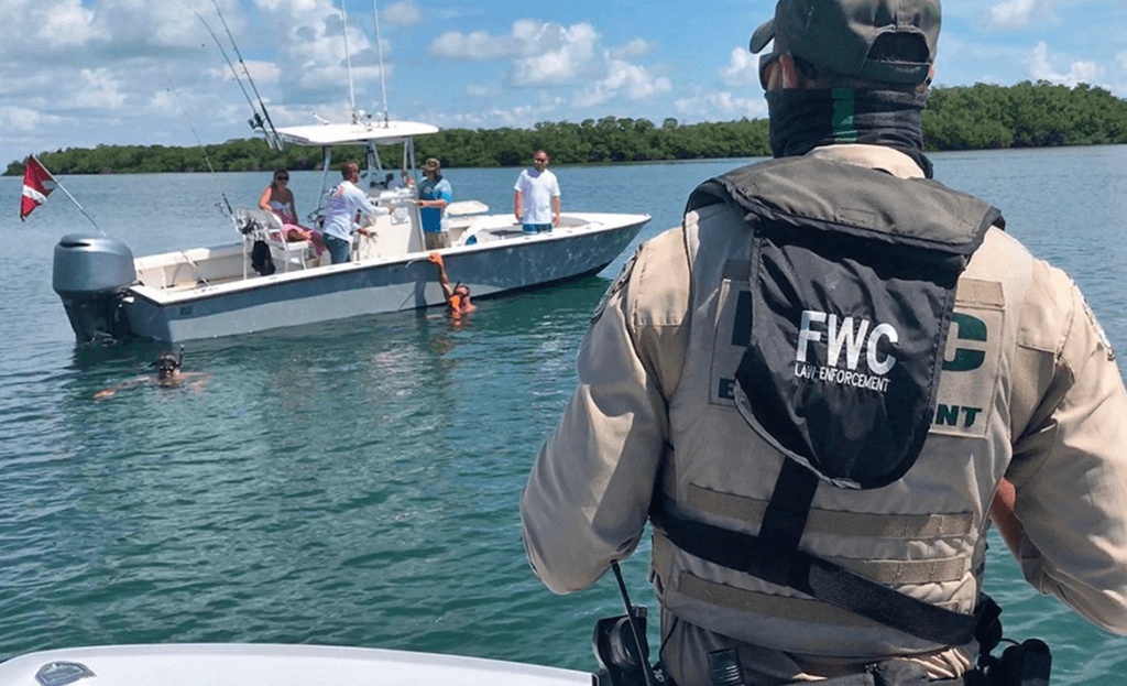 Game warden checking spearfisherman - spearfishing for beginners