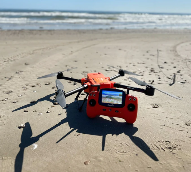 Swellpro fishing drones review - swellpro fisherman max FD2 and controller on the beach ready to fly