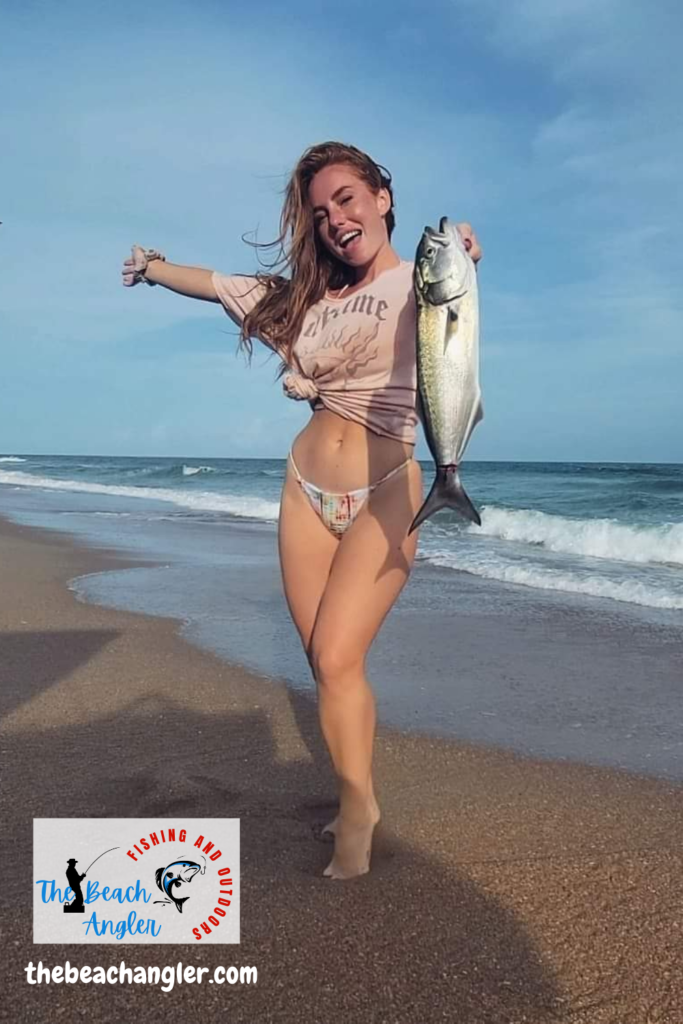 Young lady angler with a nice bluefish caught while surf fishing in Florida