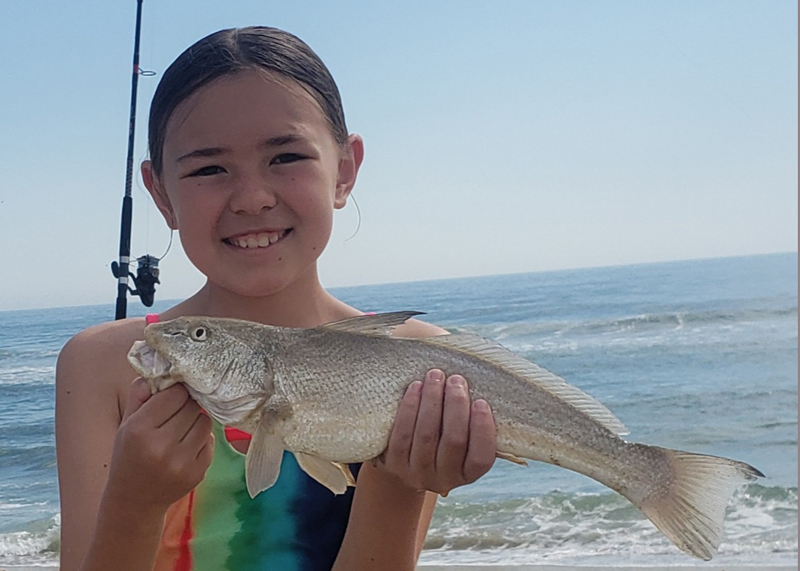 Little girl with a very nice gulf kingfish, aka whiting, caught from the beach