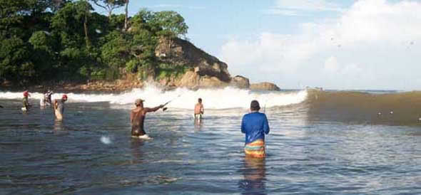 A group of surf anglers fishing a beach in Costa Rica