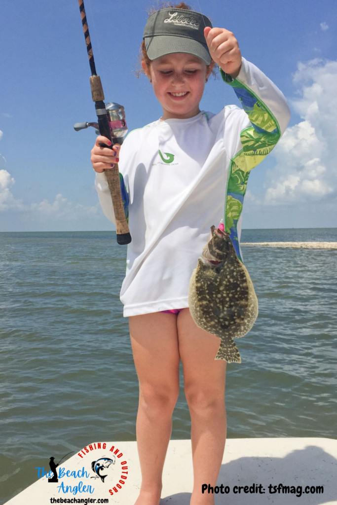 Little girl angler with a flounder she caught