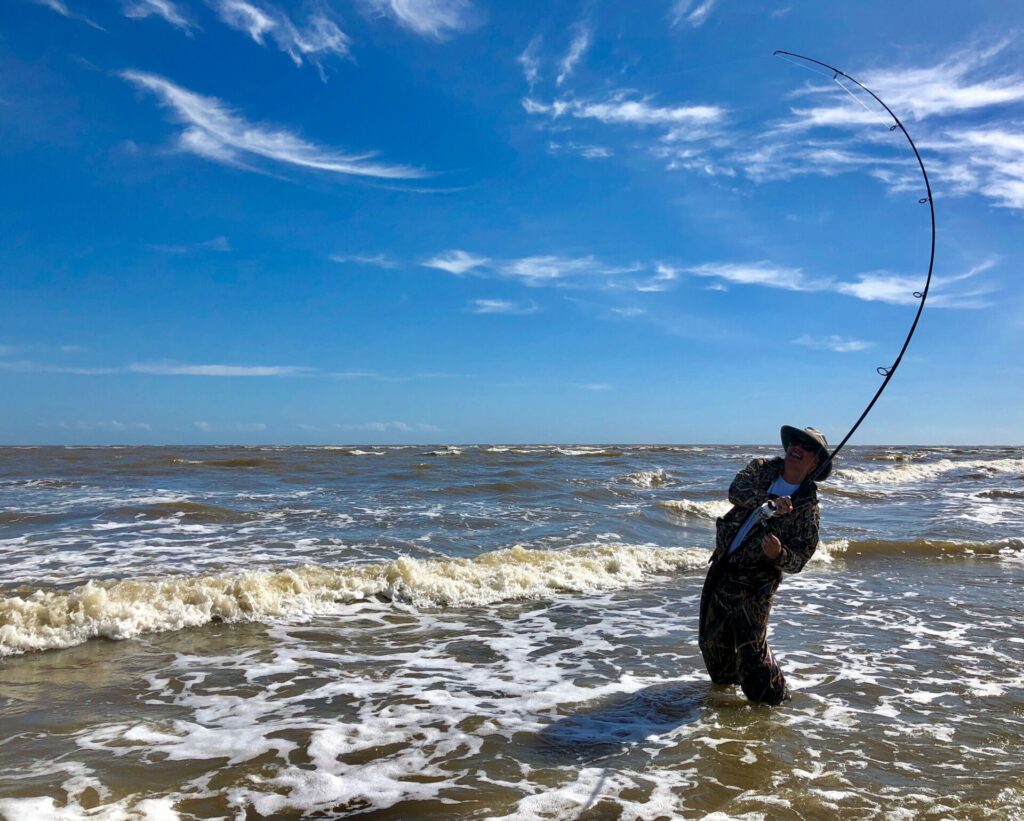 Surf fisherman hooked up with a fish while surf fishing in Myrtle Beach South Carolina