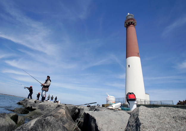 People fishing from the jetties at Barnegat Lighthouse State Park in New Jersey