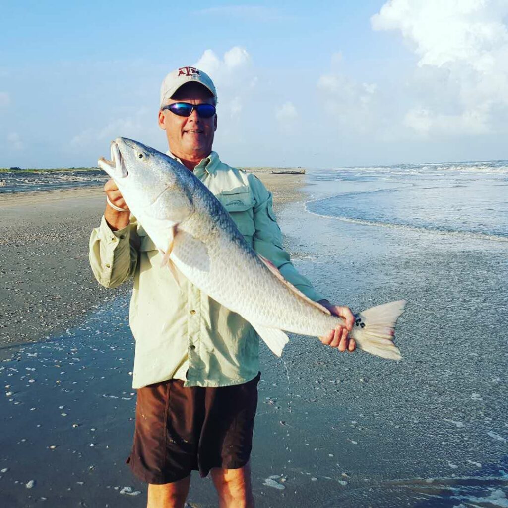 Reading the beach for fishing - author with a nice bull red drum caught from the beach in a deep trough that ran close to the shore